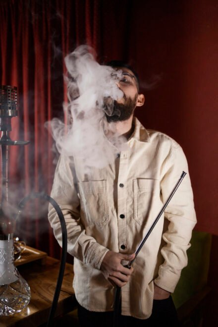 man-relaxing-by-vaping-from-hookah-bar man-relaxing-by-vaping-from-hookah-bar